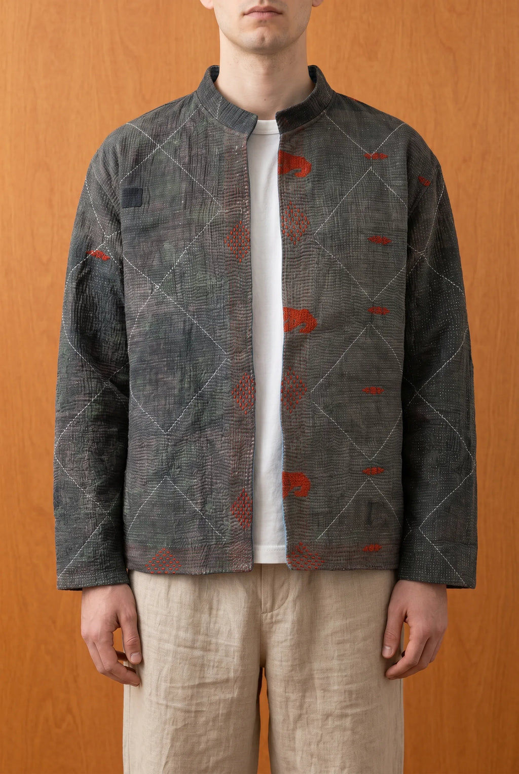 Model wearing Pratima Indigo jacket on dark grey reverse side — reversible Indian outerwear