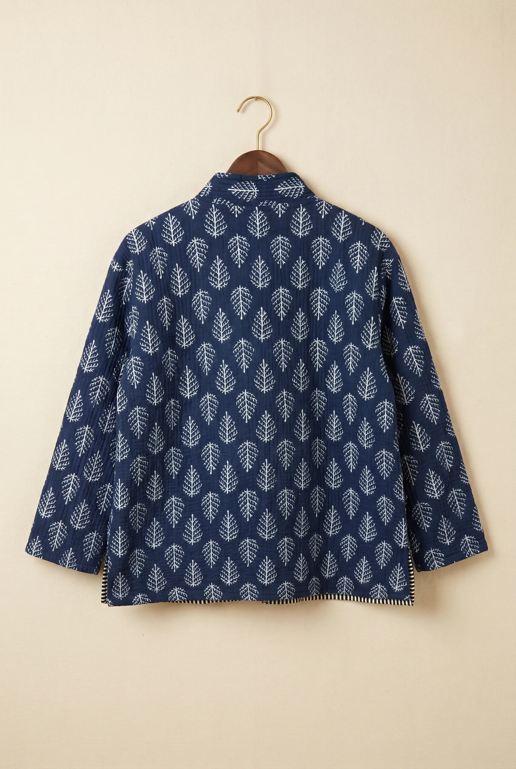 Chhipa quilted jacket — back view showing hand block-printed leaf pattern on Indian cotton